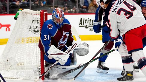 Nov 3, 2021; Denver, Colorado, USA; Colorado Avalanche goaltender Jonas Johansson (31) makes a save on Columbus Blue Jackets center Cole Sillinger (34) in the first period at Ball Arena.