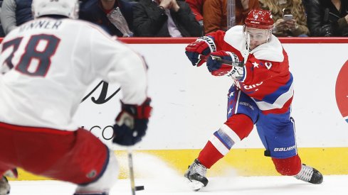 Dec 9, 2019; Washington, DC, USA; Washington Capitals defenseman Dmitry Orlov (9) shoots the puck as Columbus Blue Jackets center Boone Jenner (38) defends in the second period at Capital One Arena.