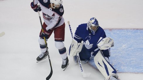 Toronto Maple Leafs goaltender Frederik Andersen (31) makes a glove save as Columbus Blue Jackets forward Boone Jenner (38) looks on during the first period of game five of the Eastern Conference qualifications at Scotiabank Arena