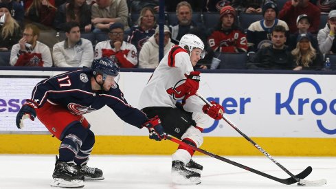 Justin Danforth pressures Jack Hughes