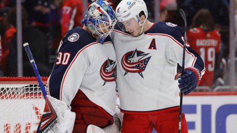 Columbus Blue Jackets' Elvis Merzlikins and Zach Werenski celebrate their win over the Washington Capitals at Capital One Arena.