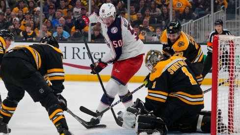 Apr 2, 2022; Boston, Massachusetts, USA; Columbus Blue Jackets left wing Eric Robinson (50) takes a shot on Boston Bruins goalie Jeremy Swayman (1) during the second period at TD Garden.