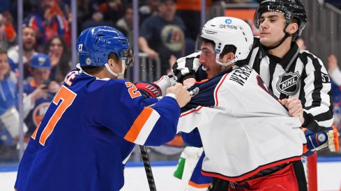 New York Islanders' Anders Lee and Columbus Blue Jackets' Zach Werenski mix it up during a game at UBS Arena.