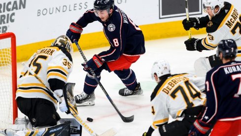 Columbus Blue Jackets defenseman Zach Werenski takes a shot ton net as he skates against Boston Bruins defenseman Charlie McAvoy in the second period at Nationwide Arena.