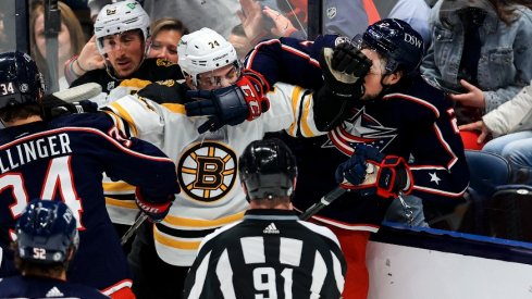 Boston Bruins left wing Jake DeBrusk (left) and Columbus Blue Jackets defenseman Andrew Peeke (right) scrum during a stop in play in the second period at Nationwide Arena.