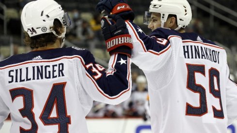 Columbus Blue Jackets forward Yegor Chinakhov celebrates with forward Cole Sillinger after scoring a goal against the Pittsburgh Penguins during the first period at PPG Paints Arena.