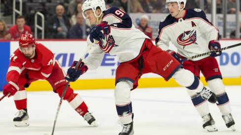 Columbus Blue Jackets' Jack Roslovic shoots and scores against the Detroit Red Wings at Little Caesars Arena.