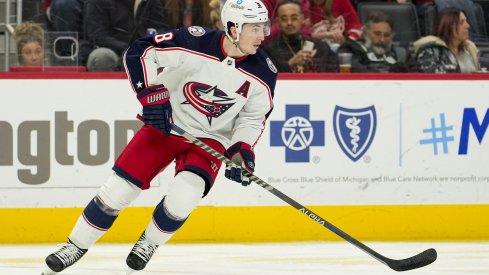 Zach Werenski skates with the puck during the second period against the Detroit Red Wings at Little Caesars Arena