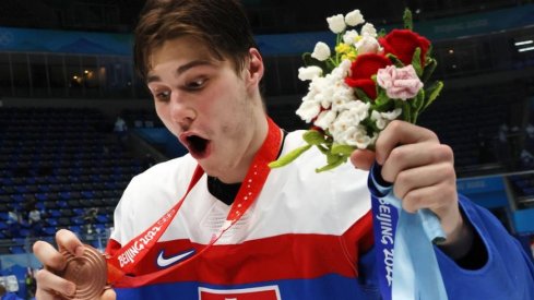 Juraj Slafkovsky celebrates after helping Slovakia earn a bronze medal in the 2022 Beijing Winter Olympics.