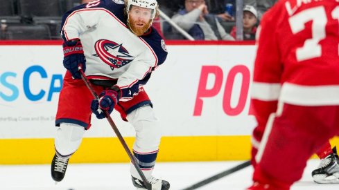 Columbus Blue Jackets right wing Jakub Voracek skates with the puck toward Detroit Red Wings center Dylan Larkin during the first period at Little Caesars Arena.