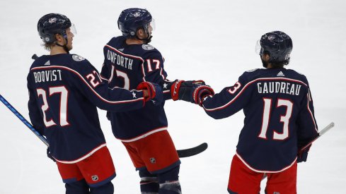 Columbus Blue Jackets' Justin Danforth celebrates his second goal with defenseman Adam Boqvist and Johnny Gaudreau during the third period against the Pittsburgh Penguins at Nationwide Arena.