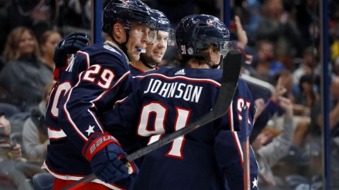 Patrik Laine celebrates a goal with Kent Johnson and Andrew Peeke