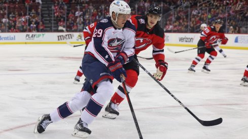 Columbus Blue Jackets left wing Patrik Laine skates with the puck while being defended by New Jersey Devils defenseman Ryan Graves during the first period at Prudential Center.