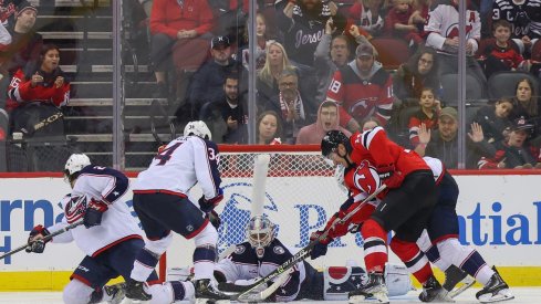 The Blue Jackets try to defend against the New Jersey Devils