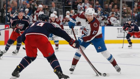 Colorado Avalanche center Tyson Jost shoots the puck against Columbus Blue Jackets defenseman Vladislav Gavrikov during the third period at Nationwide Arena.