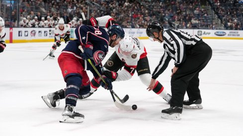 Boone Jenner and Brady Tkachuk face-off at Nationwide Arena