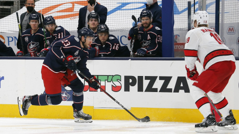 Stefan Matteau tries to flip the puck past Carolina Hurricanes defenseman Dougie Hamilton