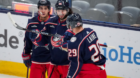 Columbus Blue Jackets left wing Kirill Marchenko, middle, celebrates with teammates left wing Johnny Gaudreau (13) and right wing Patrik Laine (29) after scoring a goal against the St. Louis Blues in the first period at Nationwide Arena.