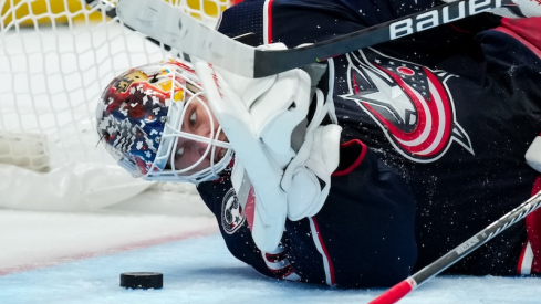 Columbus Blue Jackets' Elvis Merzlikins eyes the puck as he dives to make a save in net against the Philadelphia Flyers in the second period at Nationwide Arena.