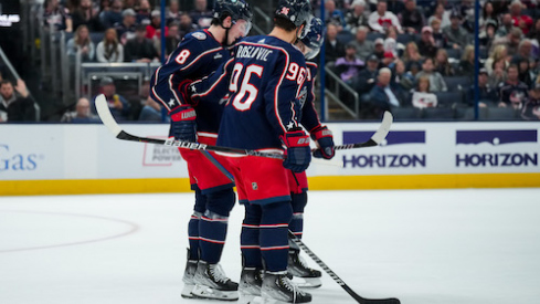 Columbus Blue Jackets defenseman Zach Werenski (8) is helped off the ice by teammates center Jack Roslovic (96) and center Sean Kuraly (7) during a stop in play against the Philadelphia Flyers in the second period at Nationwide Arena.