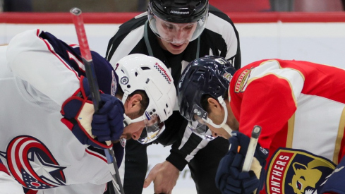 Columbus Blue Jackets center Sean Kuraly (7) and Florida Panthers right wing William Lockwood (67) face-off during the second period at Amerant Bank Arena.