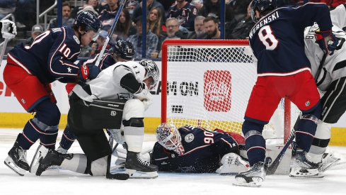 Columbus Blue Jackets' Elvis Merzlikins covers a loose puck as Los Angeles Kings' Anze Kopitar looks for the rebound during the second period at Nationwide Arena.