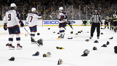 Boston Bruins fans throw their hats on the ice against the Columbus Blue Jackets at TD Garden