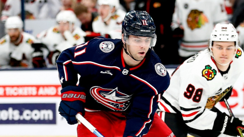 Columbus Blue Jackets center Adam Fantilli (11) shoots the puck as Chicago Blackhawks center Connor Bedard (98) trails the play during the first period at Nationwide Arena.