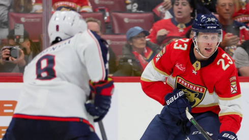 Florida Panthers center Carter Verhaeghe (23) moves the puck against Columbus Blue Jackets defenseman Zach Werenski (8) during the second period at Amerant Bank Arena.