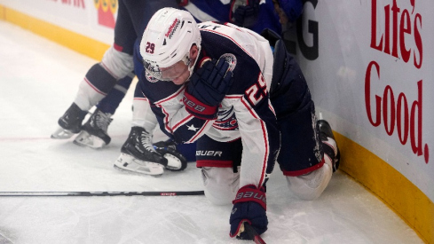 Columbus Blue Jackets forward Patrik Laine (29) grabs his shoulder after being upended by Toronto Maple Leafs defenseman William Lagesson (85) during the second period at Scotiabank Arena.