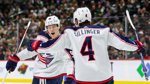 Columbus Blue Jackets center Kent Johnson (91) celebrates his goal against the Minnesota Wild with teammates center Cole Sillinger (4) and defenseman Damon Severson (78) during the second period at Xcel Energy Center.