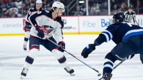 Columbus Blue Jackets forward Cole Sillinger(4) skates in on Winnipeg Jets defenseman Brenden Dillon (5) during the first period at Canada Life Centre.