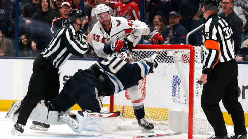 Washington Capitals right wing Tom Wilson (43) and Columbus Blue Jackets goalie Elvis Merzlikins (90) battle during overtime at Nationwide Arena.