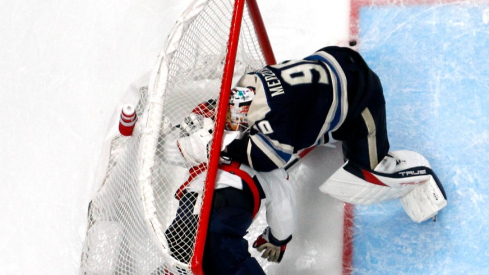 Washington Capitals right wing Tom Wilson (43) and Columbus Blue Jackets goalie Elvis Merzlikins (90) battle inside the goals during overtime at Nationwide Arena.