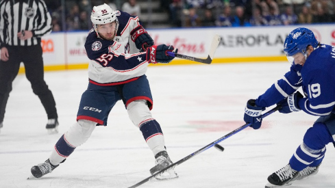 Columbus Blue Jackets defeneseman David Jiricek (55) shoots the puck past Toronto Maple Leafs forward Calle Jarnkrok (19) during the second period at Scotiabank Arena.