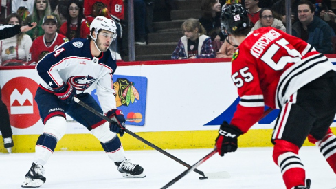 Columbus Blue Jackets center Cole Sillinger (4) moves the puck against Chicago Blackhawks defenseman Kevin Korchinski (55) during the first period at the United Center.