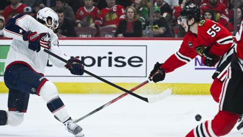 Columbus Blue Jackets' Cole Sillinger shoots the puck against Chicago Blackhawks' Kevin Korchinski during the first period at the United Center.