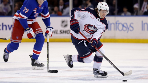 Columbus Blue Jackets center Kent Johnson (91) skates with the puck against New York Rangers center Matt Rempe (73) during the first period at Madison Square Garden.