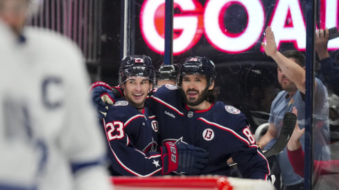 Sean Monahan and Kirill Marchenko celebrate a goal in a 6-2 win over the Toronto Maple Leafs