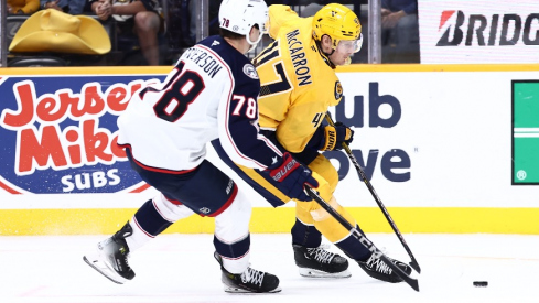 Nashville Predators right wing Michael McCarron (47) passes the puck in front of Columbus Blue Jackets defenseman Damon Severson (78) in the third period at Bridgestone Arena.