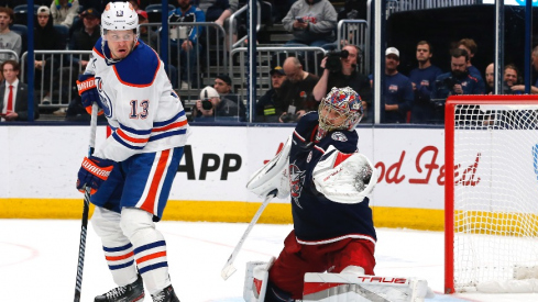 Columbus Blue Jackets goalie Elvis Merzlikins (90) makes a glove save as Edmonton Oilers center Mattias Janmark (13) looks for a rebound during the third period at Nationwide Arena.