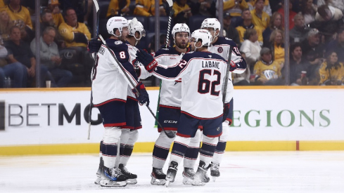 The Columbus Blue Jackets celebrate a goal by defenseman Zach Werenski (8) in the third period against the Nashville Predators at Bridgestone Arena.