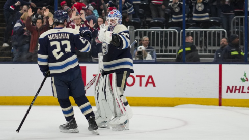 Nov 23, 2024; Columbus, Ohio, USA; Columbus Blue Jackets goaltender Elvis Merzlikins (90) and center Sean Monahan (23) celebrate after defeating the Carolina Hurricanes in a shootout at Nationwide Arena.