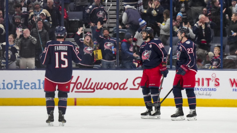 Columbus Blue Jackets right wing Kirill Marchenko (86) celebrates with teammates after scoring an empty net goal against the Calgary Flames in the third period at Nationwide Arena.