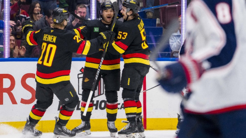 Vancouver Canucks forward Kiefer Sherwood (44) celebrates scoring with forward Danton Heinen (20) and forward Teddy Blueger (53) against the Columbus Blue Jackets during the second period at Rogers Arena.