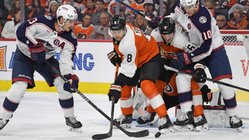 Columbus Blue Jackets center Sean Monahan (23) battles for the puck against Philadelphia Flyers defenseman Cam York (8) during the first period at Wells Fargo Center.