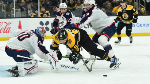 Columbus Blue Jackets defenseman Zach Werenski (8) is called for a penalty on Boston Bruins left wing Brad Marchand (63) during the third period at TD Garden.