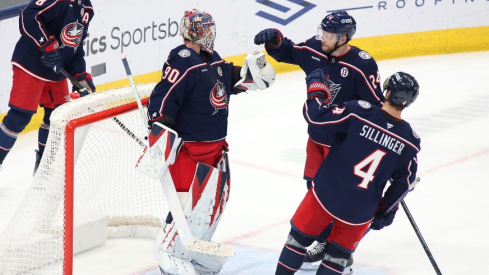 Columbus Blue Jackets goaltender Elvis Merzlikins (90) celebrates with right wing Mathieu Olivier (24) and center Cole Sillinger (4) after defeating the Columbus Blue Jackets at Nationwide Arena.