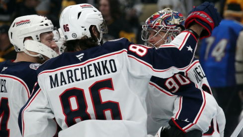 Columbus Blue Jackets right wing Kirill Marchenko (86) and goaltender Elvis Merzlikins (90) celebrate after Marchenko scored the game-winning goal in a shootout against the Pittsburgh Penguins at PPG Paints Arena.