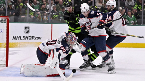 Columbus Blue Jackets goaltender Elvis Merzlikins (90) turns aside a shot as defenseman Denton Mateychuk (5) and center Adam Fantilli (19) and Dallas Stars center Mavrik Bourque (22) look on during the second period at the American Airlines Center.